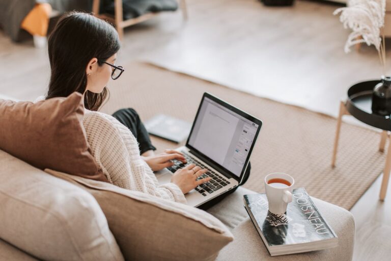 Woman creating a Wikitia page on laptop at home - Nextenco guaranteed Wikitia page creation service for $299